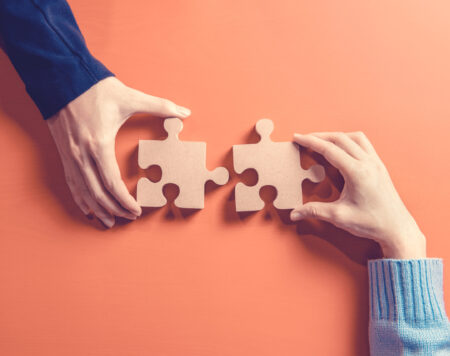 two-hands-holding-jigsaw-concept-teamwork-building-success